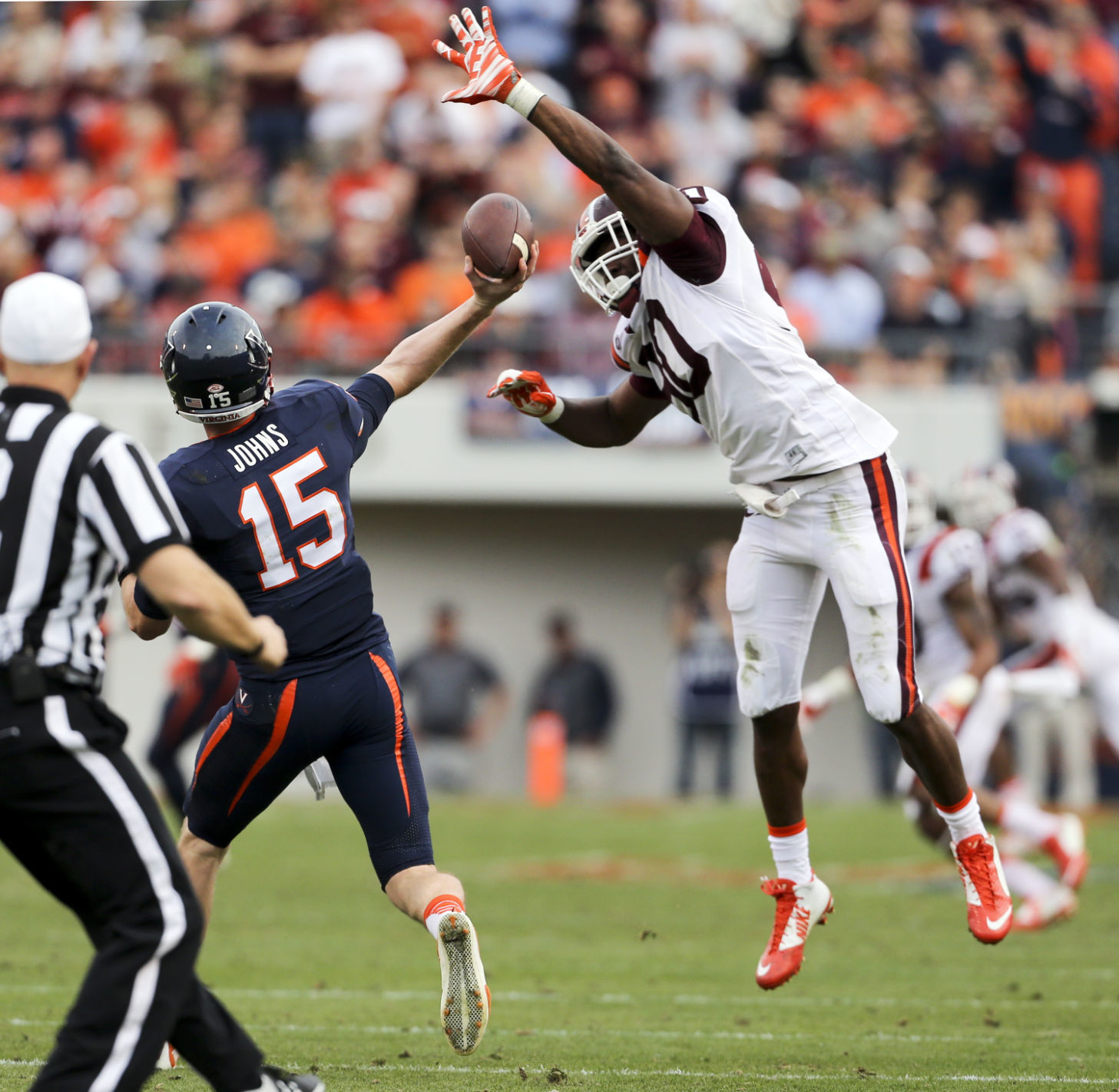 Virginia Tech’s Dadi Nicolas rushes Virginia quarterback Matt Johns